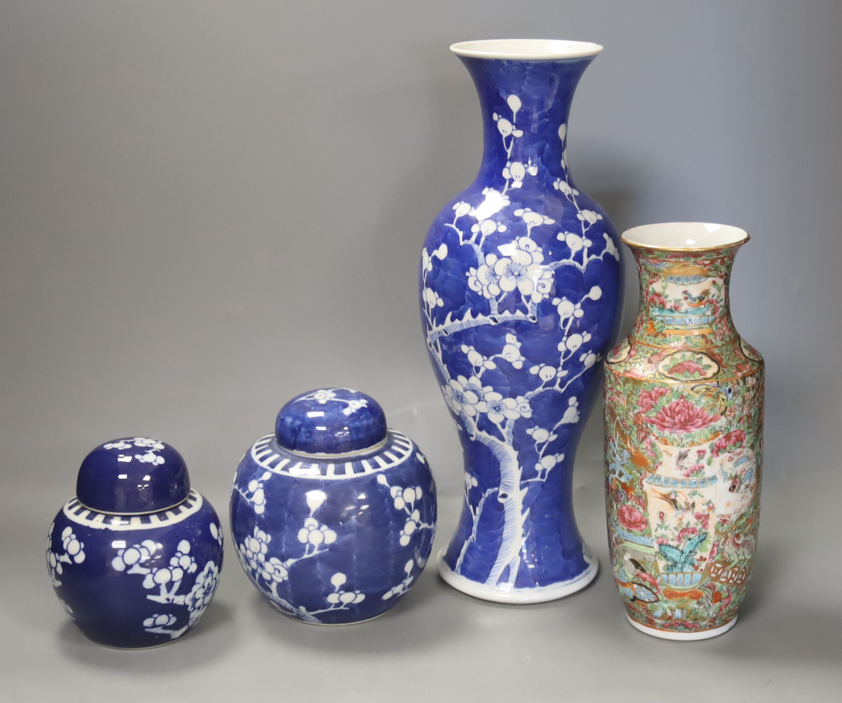 An early 20th century Chinese blue and white ‘prunus’ vase a Republic period millefleur dish, a similar Canton vase and two blue and white jars